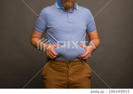 Overweight man in t-shirt on grey background, closeup. Space for text 106348655