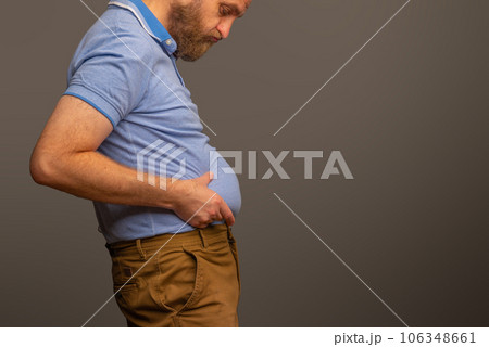 Overweight man in t-shirt on grey background, closeup. Space for text Overweight man in t-shirt on grey background, closeup. Space for text 106348661