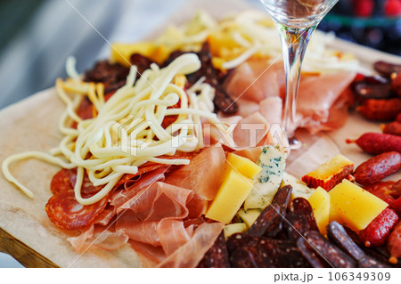 A tray with cheese and meat appetizers on the banquet table. A tray with cheese and meat appetizers on the banquet table. 106349309