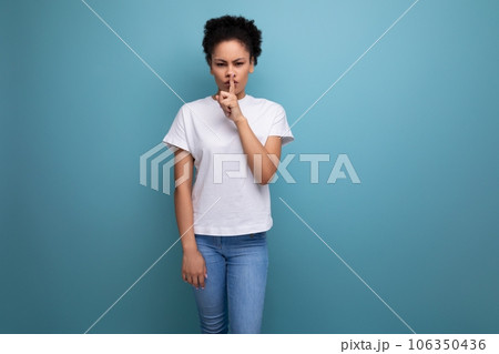 beautiful young swarthy woman with porous curly hair, dressed in a white T-shirt without a pattern beautiful young swarthy woman with porous curly hair, dressed in a white T-shirt without a pattern 106350436