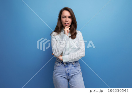 pretty young brunette woman in shirt on studio background 106350545