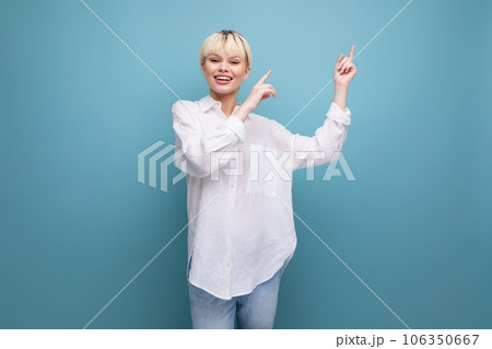 cheerful young blond business woman in a white shirt reports interesting news on the background with cheerful young blond business woman in a white shirt reports interesting news on the background with 106350667