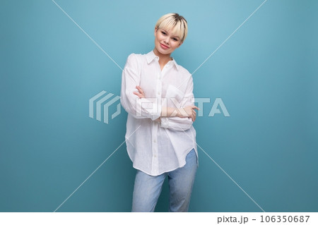 young bright caucasian blonde secretary woman dressed in a white shirt on a background with copy 106350687