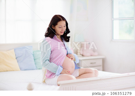Pregnant woman at home. Young expecting mother. 106351279