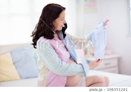 Pregnant woman at home. Young expecting mother. 106351281
