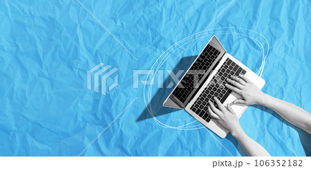 Person using a laptop computer with crumpled paper texture 106352182