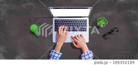 Green light bulb with a laptop computer 106352184