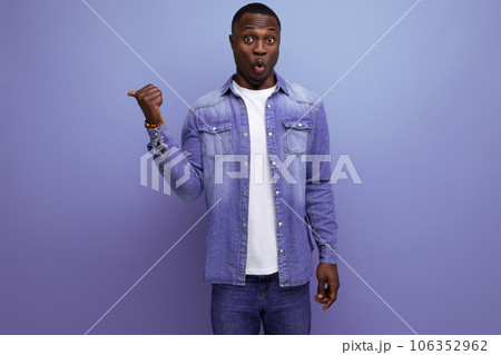 young handsome african guy in spring urban clothes pointing with his hands to the side on isolated 106352962