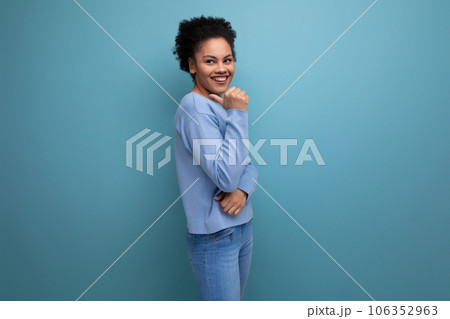 close-up of a young successful dark-skinned woman with puffy hair in blue clothes isolated close-up of a young successful dark-skinned woman with puffy hair in blue clothes isolated 106352963