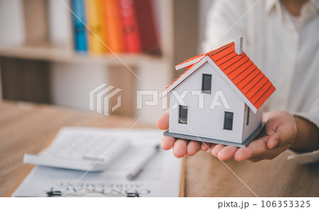 Salesperson Holding house keys concept, house keys for new house, new house purchase. Salesperson Holding house keys concept, house keys for new house, new house purchase. 106353325