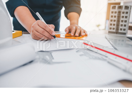 engineer working in office with blueprints, inspection in workplace for architectural plan, construction project ,Business construction 106353327