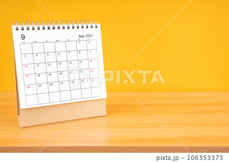 The September 2023, Monthly desk calendar for 2023 year on wooden table with yellow background. The September 2023, Monthly desk calendar for 2023 year on wooden table with yellow background. 106353373