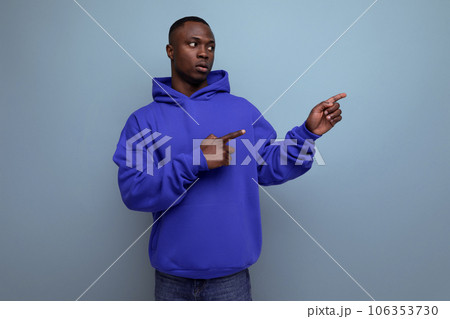 confident young black american man in casual clothes pointing to the side confident young black american man in casual clothes pointing to the side 106353730