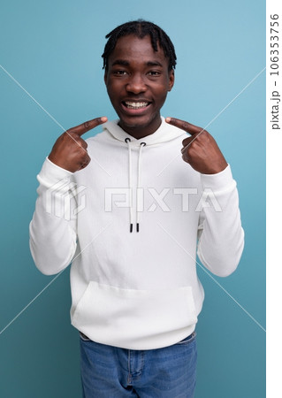 optimist smiling young african guy in white sweatshirt 106353756