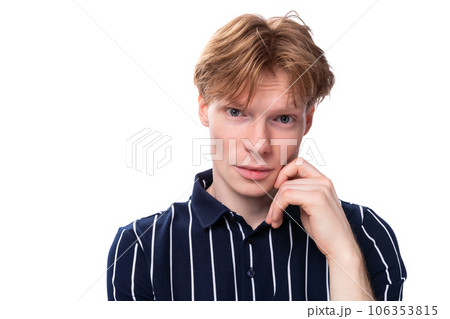 handsome young blond man in blue polo model appearance 106353815