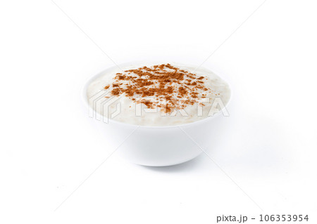 Arroz con leche. Rice pudding with cinnamon in clay bowl isolated on white background. Arroz con leche. Rice pudding with cinnamon in clay bowl isolated on white background. 106353954