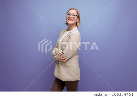 portrait of a smiling business 40s mature woman in a classic jacket on a bright background with copy portrait of a smiling business 40s mature woman in a classic jacket on a bright background with copy 106354451