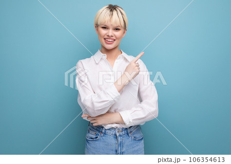 young caucasian woman with a short haircut is dressed in a white shirt on a blue background with 106354613
