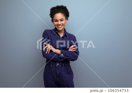 pretty brunette latin woman in blue denim suit over isolated background 106354733