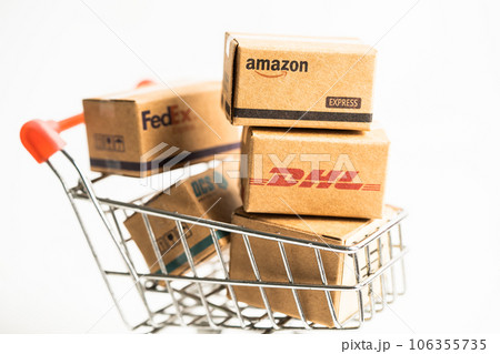 Bangkok, Thailand September 26, 2022 Shopping cart with DHL Amazon and FedEx express packing box, import export online exchange investment business. 106355735