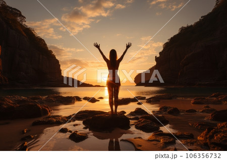 Woman practicing yoga on a secluded beach during a vibrant sunset, embodying the harmony and connection between the body and soul. Generative Ai 106356732