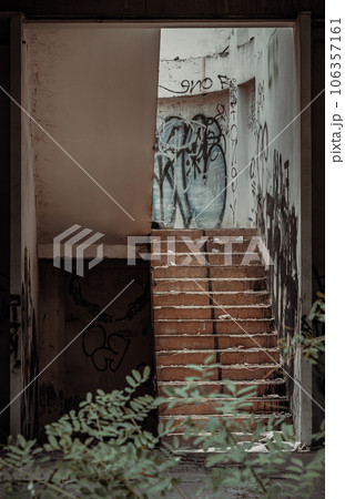 The old cement staircase and the graffiti patterns on cement wall is in the abandoned building and was left to deteriorate over years. The old cement staircase and the graffiti patterns on cement wall is in the abandoned building and was left to deteriorate over years. 106357161