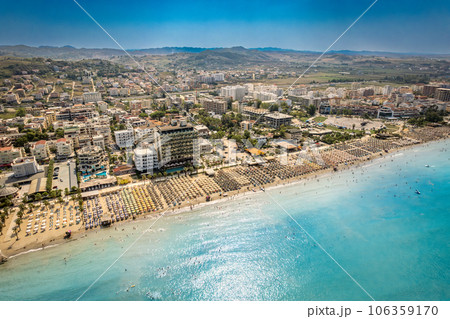 Golem, Durres, Albania - 22 august 2023: Aerial view to sandy beach full of umbrellas and people in summer season 2023 106359170