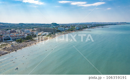 Golem, Durres, Albania - 22 august 2023: Aerial view to sandy beach full of umbrellas and people in summer season 2023 106359191