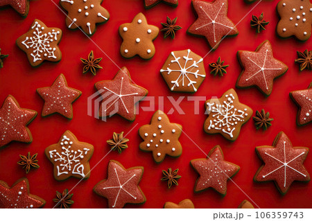 Christmas gingerbread cookies on red background. Top view Christmas gingerbread cookies on red background. Top view 106359743