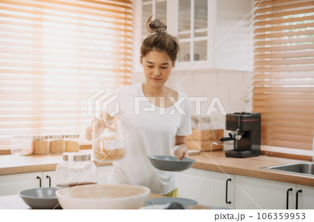 Woman enjoy cooking simple noodle in the kitchen as a hobby. Woman enjoy cooking simple noodle in the kitchen as a hobby. 106359953