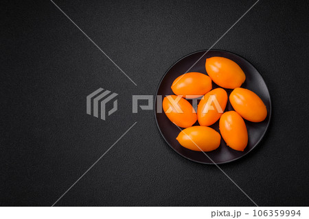 Bright juicy fresh yellow plum-shaped tomatoes 106359994
