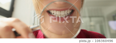 Woman young laughing mouth through a magnifying glass Woman young laughing mouth through a magnifying glass 106360496