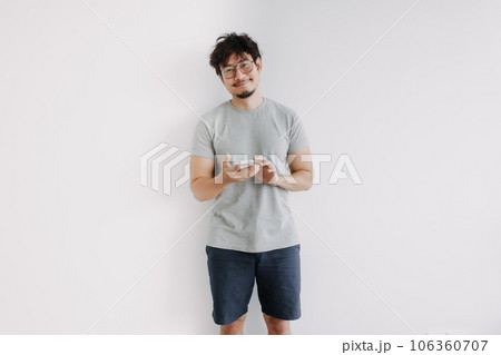 Bored face man feeling happy with the application in mobile phone. 106360707