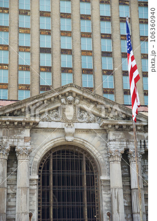 DETROIT, MICHIGAN, UNITED STATES - MAY 5th 2018: A view of the old Michigan Central Station building in Detroit which served as a major railway depot from 1914 - 1988, detailed view with the american 106360940