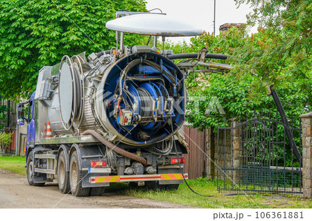 Truck mounted combined vacuum suction and canal jetting machine in action in city utilities 106361881