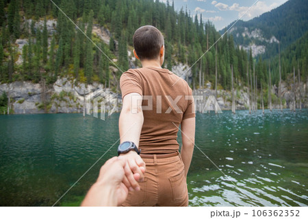 Follow me. A woman brought her man on a date in nature. Spend time on the mountain lake Kaindy in Qazaqstan 106362352