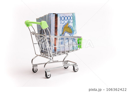 Bundle of Kazakh money in ten thousandth bills in a grocery cart isolated on white background 106362422