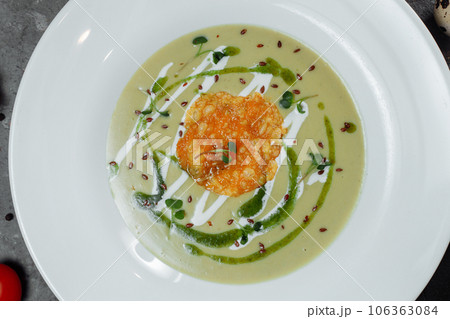 Spinach soup with croutons in white bowl 106363084