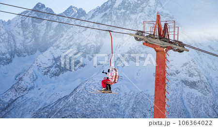 People are lifting on open lft high up in Caucasus mountains People are lifting on open lft high up in Caucasus mountains 106364022