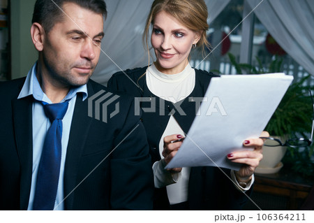 Happy Mature Businessman And Businesswoman working with documents 106364211