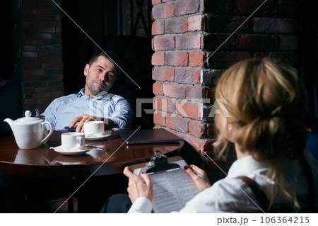 Happy business people working together on laptop in a restaurant Happy business people working together on laptop in a restaurant 106364215