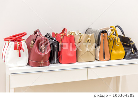 Collection of handbags standing in a row 106364585