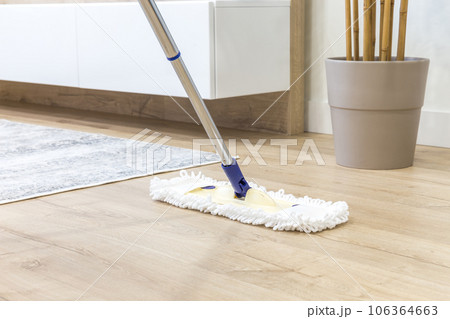 Wooden floor with white mop, cleaning service concept 106364663