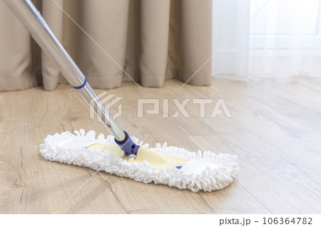 Modern white mop cleaning a wooden floor Modern white mop cleaning a wooden floor 106364782