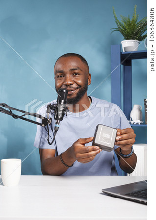 Smiling streamer hosting giveaway marketing campaign and broadcasting live for social media networks portrait. Influencer announcing contest with prize and speaking to subscribers Smiling streamer hosting giveaway marketing campaign and broadcasting live for social media networks portrait. Influencer announcing contest with prize and speaking to subscribers 106364806