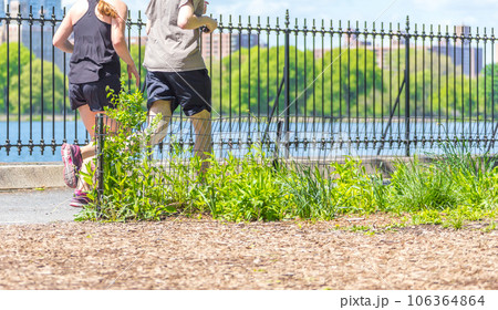 Healthy fit and sportive couple running in nature at summer day 106364864