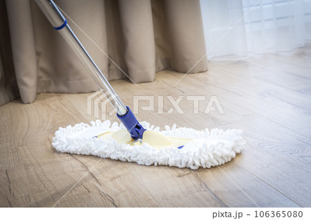 Modern white mop cleaning a wooden floor Modern white mop cleaning a wooden floor 106365080