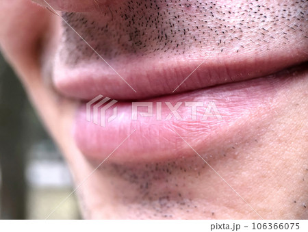 Closeup of the mouth of a smiling man with a little stubble. Parts of the human body, lips. 106366075