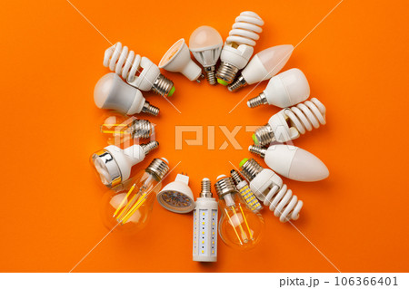 Many light bulbs on bright orange background Many light bulbs on bright orange background 106366401