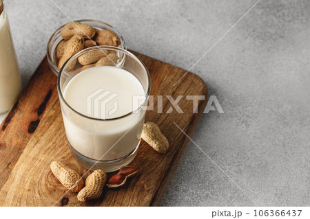 Vegan peanut milk in glass with peanuts 106366437